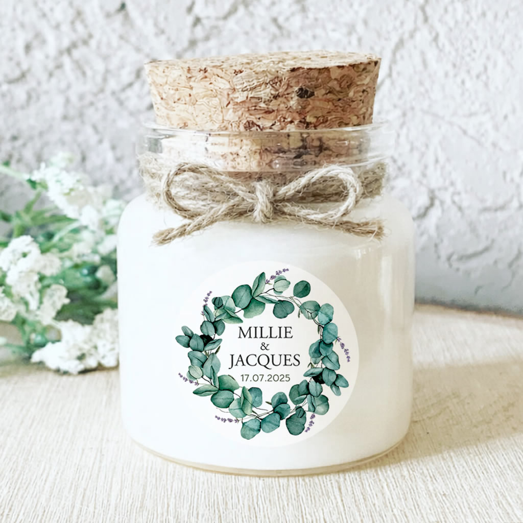 Bougie personnalisée mariage avec couronne d’eucalyptus vert, pot en verre liège, idée cadeau invité artisanale et naturelle.